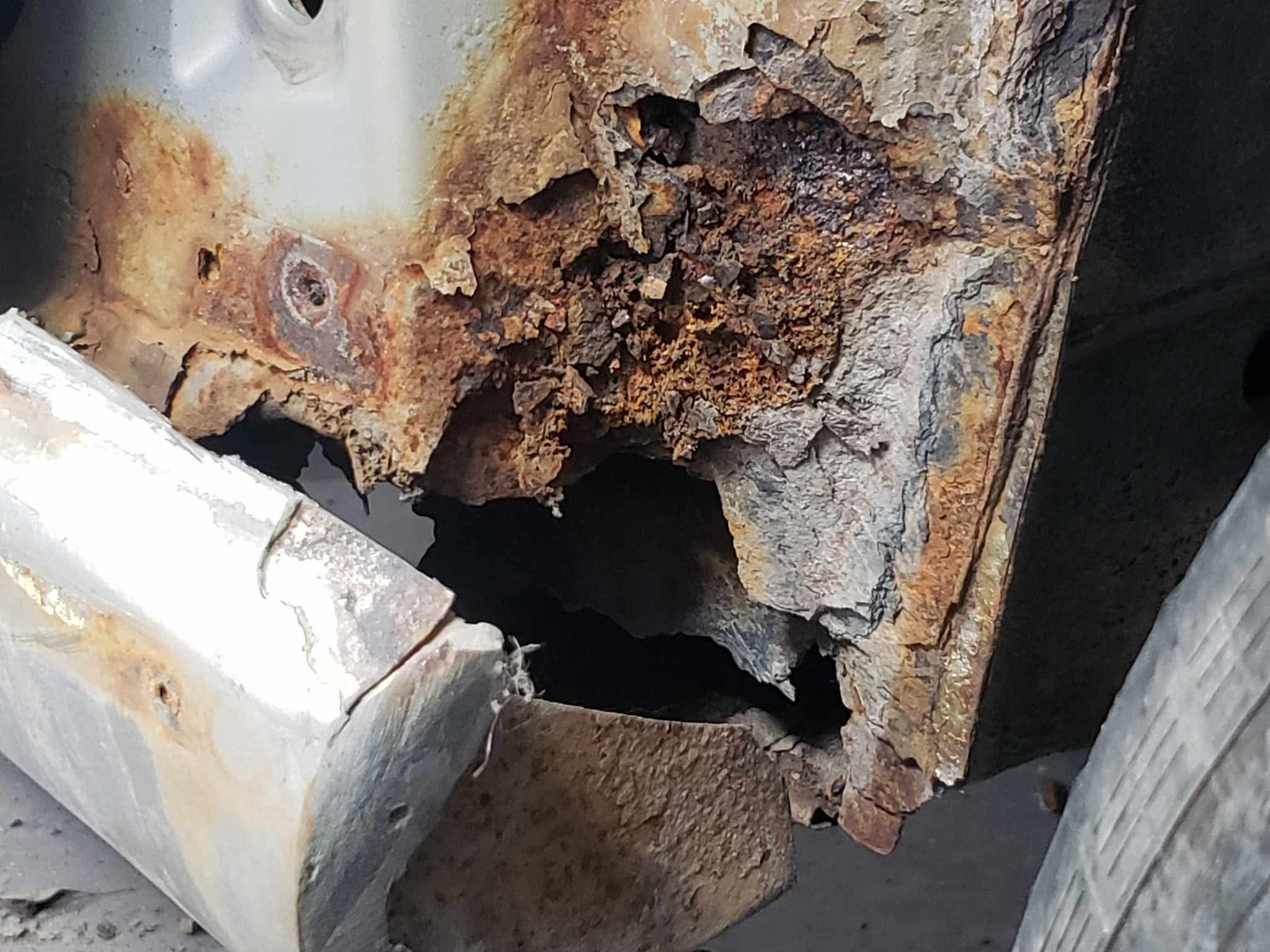 Rear quarter rust — through to daylight